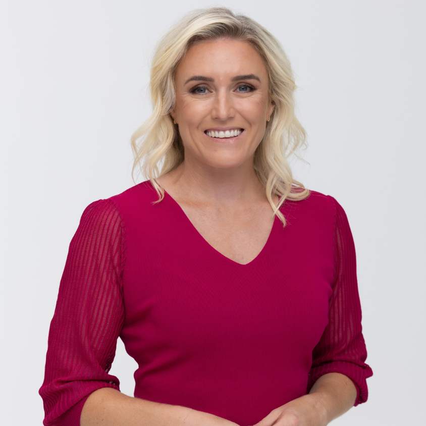 Sally Pearson wearing a pink blouse against a white background