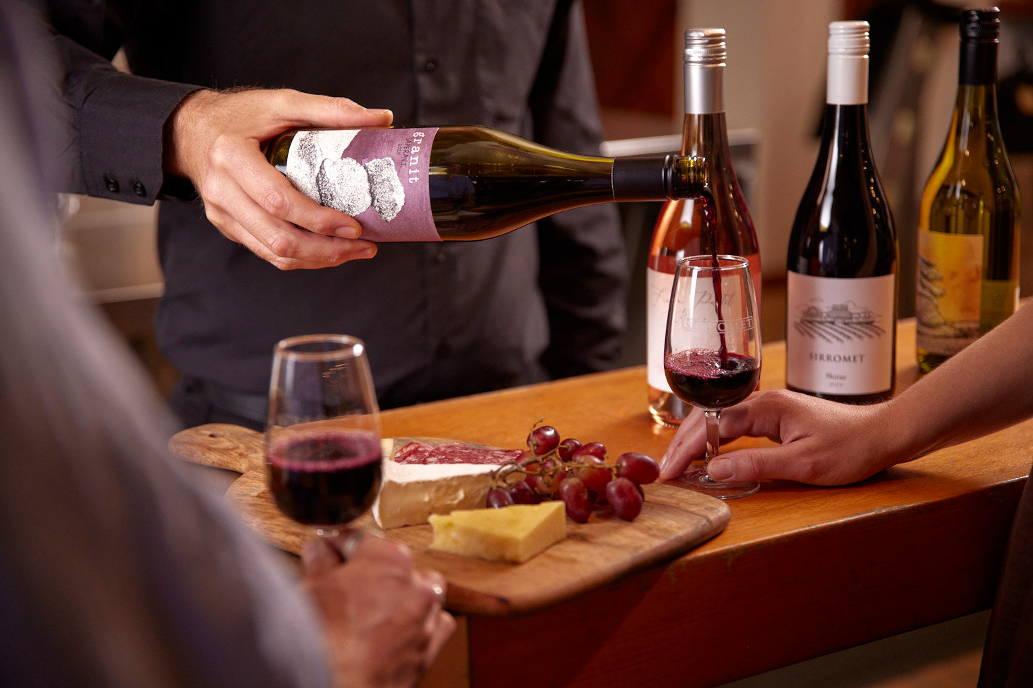 Wine bottles with cheese platter at Sirromet wine tasting