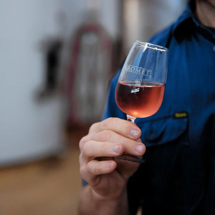Winemaker swirling wine in a glass