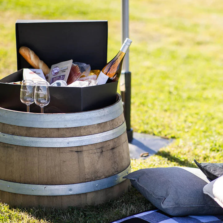 Wine and food hamper on top of a small barrel