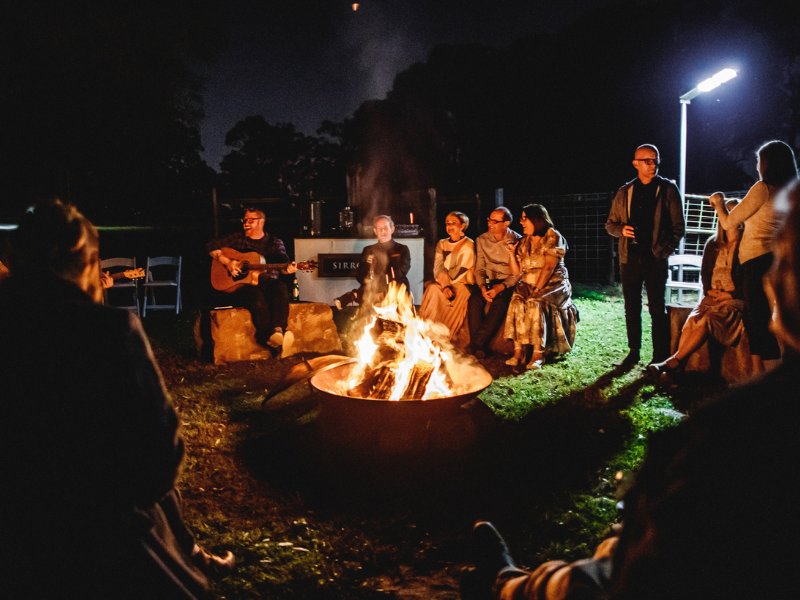 Corporate event participants around fire pit