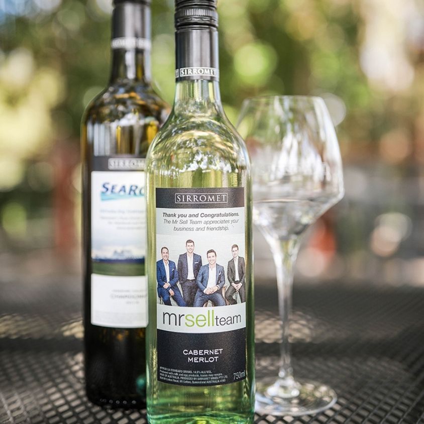 Two customised wine label wine bottles and one glass