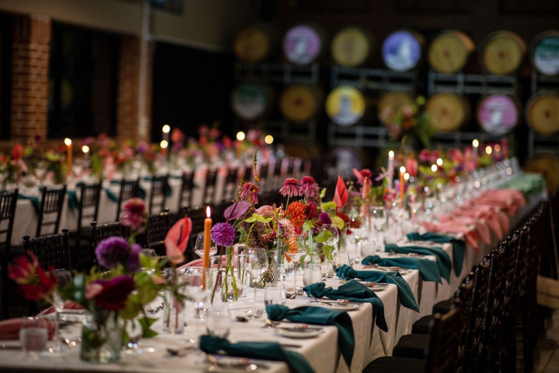two rows of long dining tables set up for private function guests in the Barrel Room