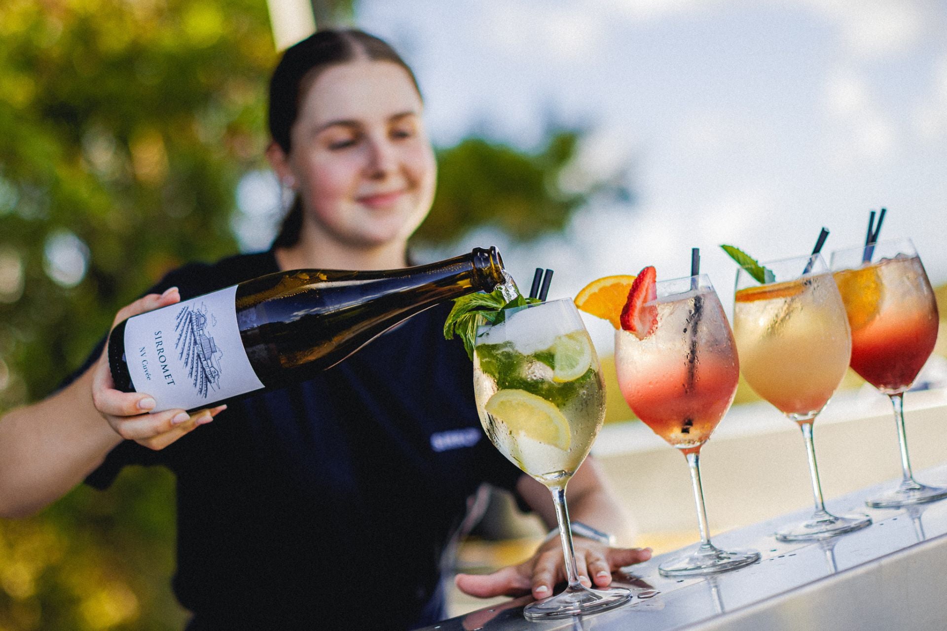 Woman pouring glasses of Sirromet wine