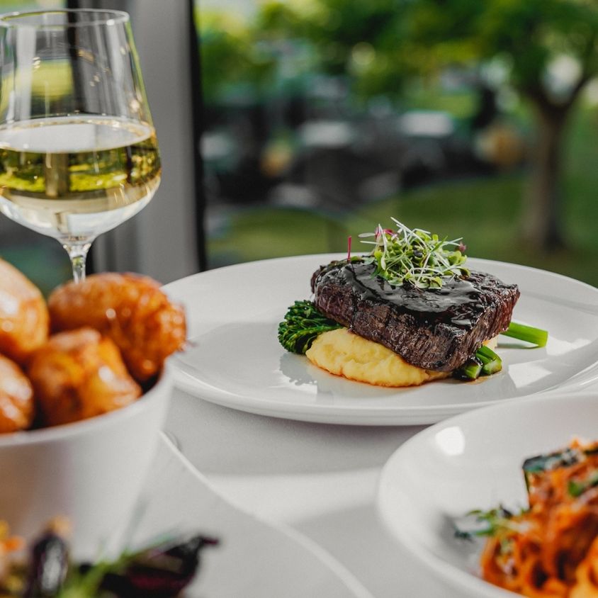plates of food and wine on Tuscan terrace dining table