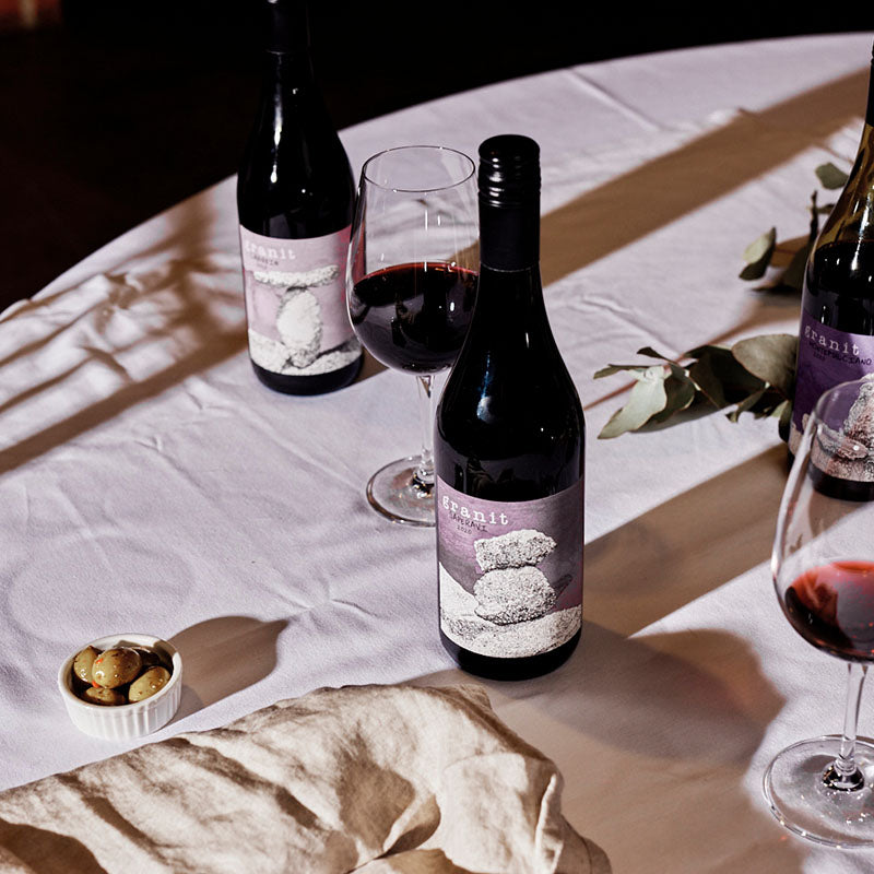 Two bottles of Garnit collection wine bottles and two glasses