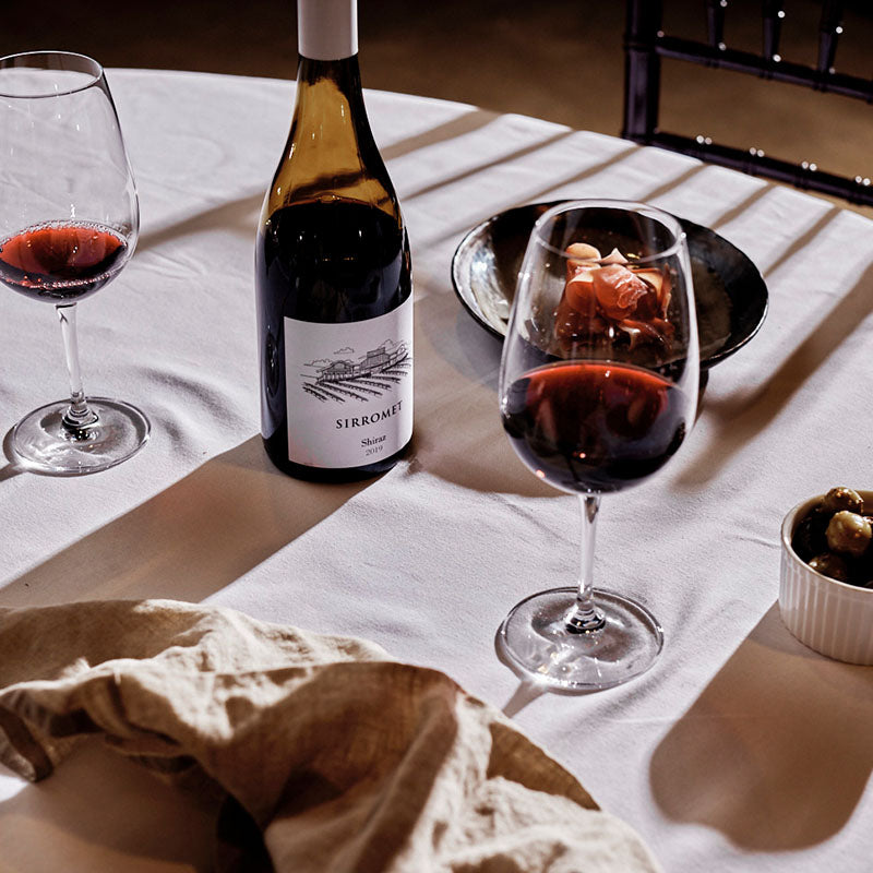 Bottle of Sirromet Shiraz wine and two wine glasses