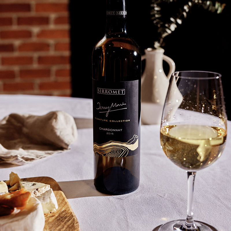Bottle of Signature Collection wine and one glass